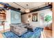 Open living area with sectional sofa, hardwood floors, and exposed ductwork, near dining area at 2020 Arapahoe St # 1070, Denver, CO 80205