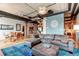 Open concept living area with exposed ductwork, hardwood floors, and comfortable sectional sofa at 2020 Arapahoe St # 1070, Denver, CO 80205
