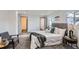 Bright bedroom featuring a bed with soft pillows, an AC unit, and open doorways at 4445 Milwaukee St, Denver, CO 80216
