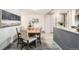 Dining room features a wooden table with upholstered chairs and views to the kitchen at 4445 Milwaukee St, Denver, CO 80216