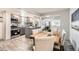 A well lit open-concept kitchen featuring a breakfast bar and stainless steel appliances at 4445 Milwaukee St, Denver, CO 80216