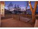 Evening view of a spacious deck with string lights, overlooking a fenced backyard at 6765 Tabor St, Arvada, CO 80004