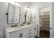 Modern bathroom with double vanity and walk-in closet at 6765 Tabor St, Arvada, CO 80004