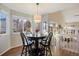 Bright dining area with a table and four chairs, overlooking the kitchen at 6765 Tabor St, Arvada, CO 80004