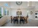 Dining area with a wooden table and six chairs, complemented by a large clock at 6765 Tabor St, Arvada, CO 80004