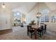 Bright dining area with a wooden table, six chairs, and an open floor plan at 6765 Tabor St, Arvada, CO 80004