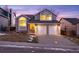 Two-story home with a gray exterior, two-car garage, and landscaped front yard at 6765 Tabor St, Arvada, CO 80004