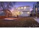 Two-story house exterior with a deck and backyard at dusk at 6765 Tabor St, Arvada, CO 80004