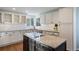 Modern kitchen with granite island, stainless steel appliances, and white cabinets at 6765 Tabor St, Arvada, CO 80004