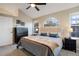 Main bedroom with a ceiling fan and large windows at 6765 Tabor St, Arvada, CO 80004