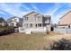 Exterior view of the backyard with a deck and a hot tub, surrounded by a grassy lawn at 10532 Wintersweet Ct, Parker, CO 80134