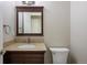 Powder room featuring a granite countertop, vanity, and decorative mirror at 10532 Wintersweet Ct, Parker, CO 80134