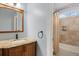 Bathroom featuring a granite countertop vanity and tiled shower and tub combo at 10532 Wintersweet Ct, Parker, CO 80134