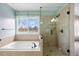 Bright bathroom with soaking tub and glass enclosed shower at 10532 Wintersweet Ct, Parker, CO 80134