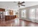 Open-concept living area with a kitchen island, hardwood floors, and lots of natural light at 10532 Wintersweet Ct, Parker, CO 80134