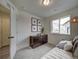 Simple bedroom with dark dresser and window seat at 12940 E 103Rd Ave, Commerce City, CO 80022