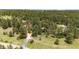 Aerial view of a sprawling property features a winding driveway and serene, tree-filled surroundings at 8788 E Tanglewood Rd, Franktown, CO 80116
