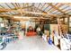 Spacious barn interior with high ceilings, tractor, storage racks, and ample space for storage or workshop at 8788 E Tanglewood Rd, Franktown, CO 80116