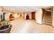 A large finished basement area featuring wall to wall carpet and access to the home's staircase at 8788 E Tanglewood Rd, Franktown, CO 80116