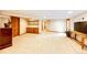 Spacious basement area with custom built-in shelving and soft neutral carpet at 8788 E Tanglewood Rd, Franktown, CO 80116