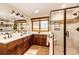 Elegant bathroom featuring dual vanities, a tiled walk-in shower, and modern fixtures at 8788 E Tanglewood Rd, Franktown, CO 80116