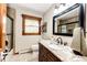Bathroom featuring a vanity with granite top, dark wood cabinets, a shower and tile floors at 8788 E Tanglewood Rd, Franktown, CO 80116