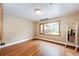 Sunlit bedroom with hardwood floors and view to the outside porch at 8788 E Tanglewood Rd, Franktown, CO 80116