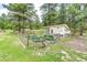 Well-maintained chicken coop with a fenced garden area, creating a charming and functional backyard feature at 8788 E Tanglewood Rd, Franktown, CO 80116