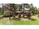 A charming home exterior surrounded by lush greenery and mature trees at 8788 E Tanglewood Rd, Franktown, CO 80116