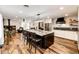Open kitchen features a large center island and modern appliances at 8788 E Tanglewood Rd, Franktown, CO 80116