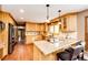 Bright eat-in kitchen with granite countertops, stainless steel appliances, and wood floors at 8788 E Tanglewood Rd, Franktown, CO 80116