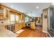 Well-equipped kitchen featuring wood cabinets, granite countertops, and stainless steel appliances at 8788 E Tanglewood Rd, Franktown, CO 80116