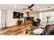 Cozy living room with hardwood floors, a stone fireplace, and comfortable seating at 8788 E Tanglewood Rd, Franktown, CO 80116