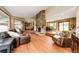 Spacious living room featuring a stone fireplace, hardwood floors, and large windows at 8788 E Tanglewood Rd, Franktown, CO 80116
