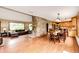 Spacious living and dining area featuring hardwood floors, a stone fireplace, and plenty of natural light at 8788 E Tanglewood Rd, Franktown, CO 80116