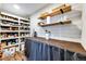 Well-organized pantry with ample shelving and counter space for storage and food preparation at 8788 E Tanglewood Rd, Franktown, CO 80116