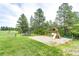 A charming playground with swing set, slide, trampoline, and beautiful greenery at 8788 E Tanglewood Rd, Franktown, CO 80116