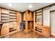 Custom walk-in closet with built-in shelving, drawers, and ample storage space for organized living at 8788 E Tanglewood Rd, Franktown, CO 80116