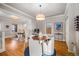 Cozy dining area includes a round table, white chairs, and hardwood floors at 4234 N Raleigh St, Denver, CO 80212