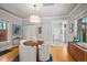 Well-lit dining area with a round table and white chairs, near kitchen access at 4234 N Raleigh St, Denver, CO 80212