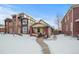 Brick bungalow home exterior, snowy front yard, walkway at 4234 N Raleigh St, Denver, CO 80212