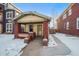 Brick bungalow home exterior, snowy front yard, walkway at 4234 N Raleigh St, Denver, CO 80212