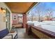 Front porch with brick columns and wicker seating at 4234 N Raleigh St, Denver, CO 80212