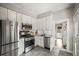 Modern kitchen with stainless steel appliances and white cabinetry at 4234 N Raleigh St, Denver, CO 80212