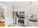 Updated kitchen featuring stainless steel appliances and white cabinetry at 4234 N Raleigh St, Denver, CO 80212