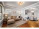 Living room with L-shaped sofa, hardwood floors, and dining area at 4234 N Raleigh St, Denver, CO 80212