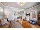 Living room with L-shaped sofa, hardwood floors, and dining area at 4234 N Raleigh St, Denver, CO 80212