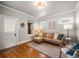 Light-filled living room features hardwood floors, a comfortable couch, and an inviting atmosphere at 4234 N Raleigh St, Denver, CO 80212