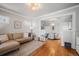 Living room with L-shaped sofa, hardwood floors, and dining area at 4234 N Raleigh St, Denver, CO 80212