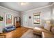 Living room with L-shaped sofa, hardwood floors, and entryway at 4234 N Raleigh St, Denver, CO 80212